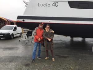 Barry and Mary Ann standing in front of a Lucia 40 Fountaine Pajot
