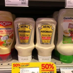 Two American Sauce bottles on grocery store shelf