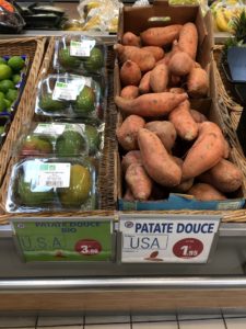 Yams and avocado for sale on display in grocery store