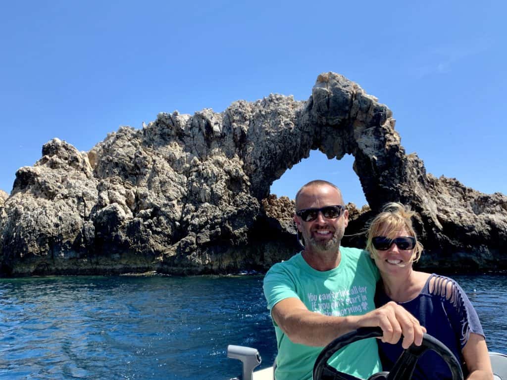Matt & Emily in our dinghy in front of sea arch